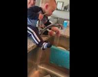 Kid on sink turn on and off faucet