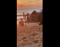 Woman two piece poses at beach sunset