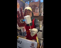 Vendor using iron man hand to toast mallows 