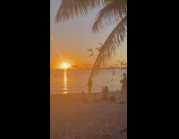 Woman poses for a photo at the beach 
