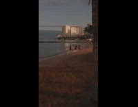 Four boys unsync dance at beach night