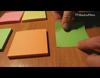 Guy alternates colorful post it notes slinky 
