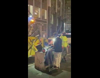 Guy djs next to garbage truck 