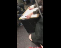Woman has canvas on her lap and paints man on subway