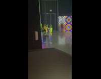 Four women dance and selfie inside the exhibit