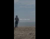 Person black dress covers face dances beach