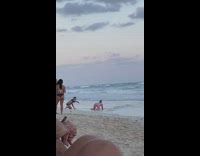 Man in pink shorts lie down and reveals butt at the beach