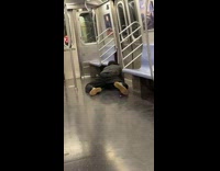Man lays on empty subway floor