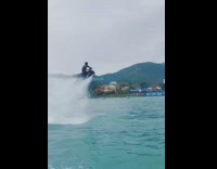 Guy flying jet ski does spin roll 
