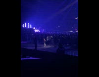 Woman dances on  side of music festival