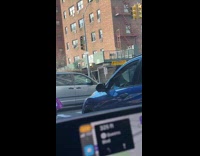 Clown juggle pins in front of cars