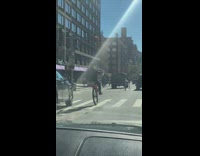 Guy orange bicycle wheelie no front wheel 