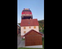 Firetruck hot air balloon fly  near houses