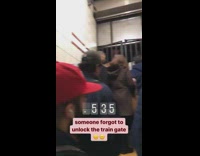 Subway passengers stuck behind locked gates in train station and wait for cops to unlock doors