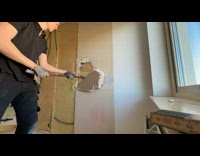 Time lapse man demolish wall inside house