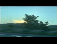 Sunrise over a mountain car ride window