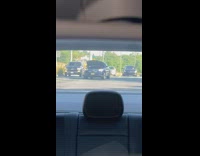 Person driving on street with front hood up pulls over 
