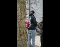 Two guys hold bouquet of flowers 