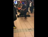 Guy does fast step dance to live band music in subway station
