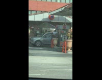Guy standing top of car gas station
