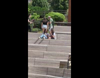 Woman in black top jump ropes at the park