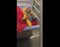 Red sweater guy yellow scarf lays subway 