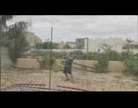 Old man dances with a big hula hoop at the backyard