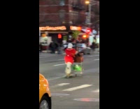 Man rides skateboard push cart on street