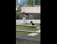 Woman in white dress dancing for tiktok content