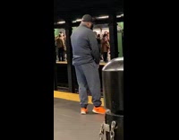 Guy orange shoes hits a high note and sings in subway station