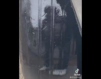 Guy looks at his tire and shows that it is bald and has his reflection