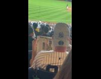 Man reads newspaper instead of watching game