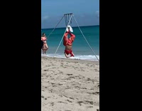 Woman large red bikini hang upside down spin