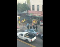 Four guys in suits watching construction while smoking