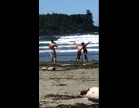 Pink shorts guy handstand girl holds legs 