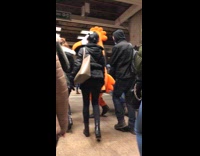 person dressed as giant orange bird subway