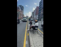 Guy does photoshoot on skinny road barrier 
