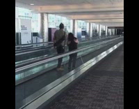 Couple TikTok dance airport walkway tripod camera 