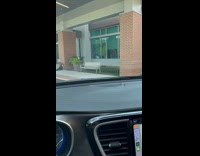 Man picking up fainted wife outside establishment 