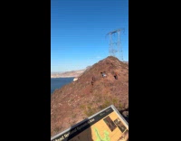 Woman blue dress poses on mountain rocks