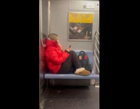 Woman red jacket occupies whole train seat