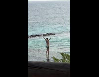 Man shirtless raise hands pose beach resort