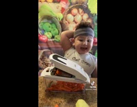 Little chef boy karate chops slices vegetables 