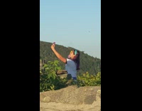 White shirt girl holds yellow flower selfie 