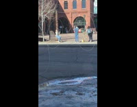 guy takes picture of girl in stripes sitting on bench