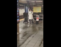 Woman white coat sing karaoke in subway