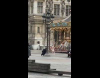 Lady poses by carousel 