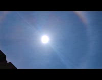 Rainbow halo around the sun blue sky