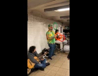 Man juggles with band at the subway