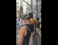 Person clown costume wig sits street protest